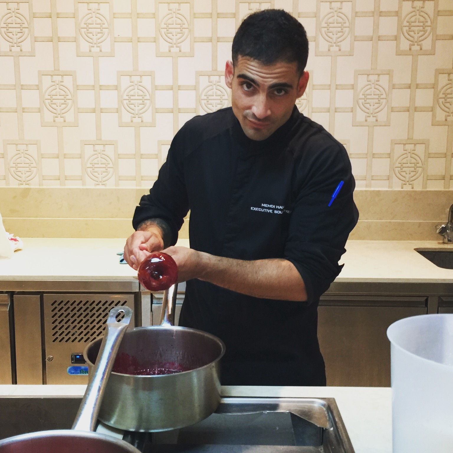 Chef Mehdi preparing candy apples in a professional kitchen