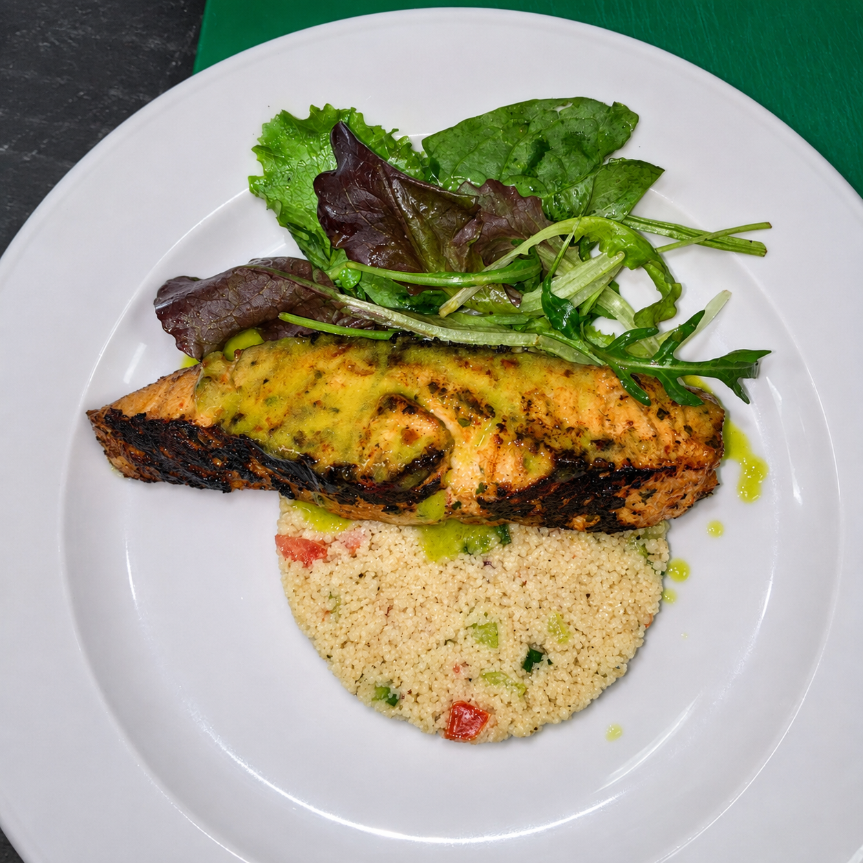 Salmon with couscous and seasonal greens
